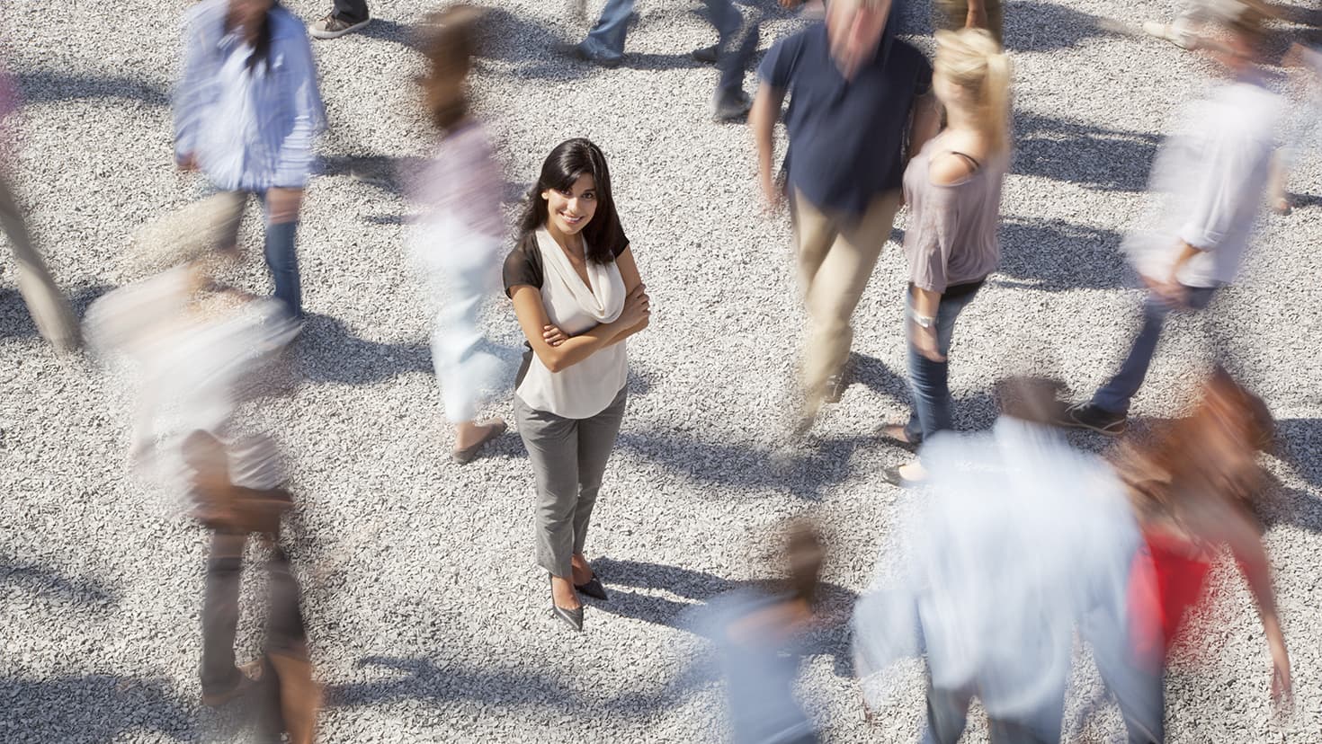 Eine Frau steht inmitten von vorbeilaufenden Menschen. © Rob Daly/KOTO - stock.adobe.com